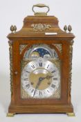 A burr walnut cased bracket clock, the brass dial with sun and moon phase, silvered chapter ring and