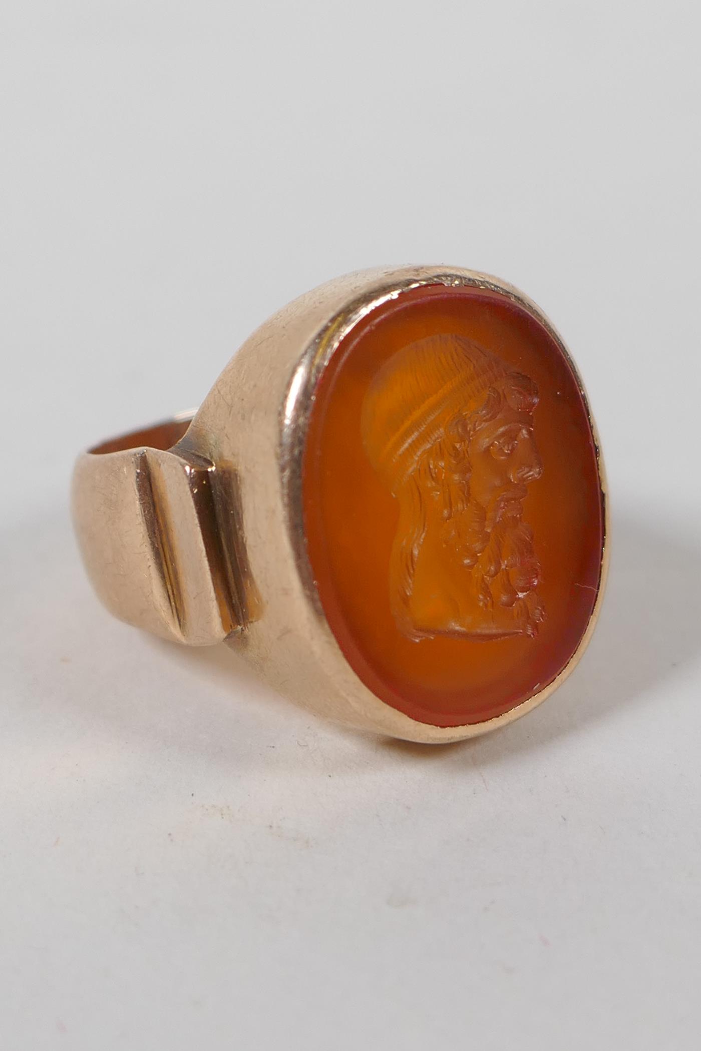 An antique intaglio ring, with finely carved inset stone in an antique high carat gold mount, approx