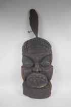 An antique African carved hardwood wall mask, 74cm high x 26cm wide