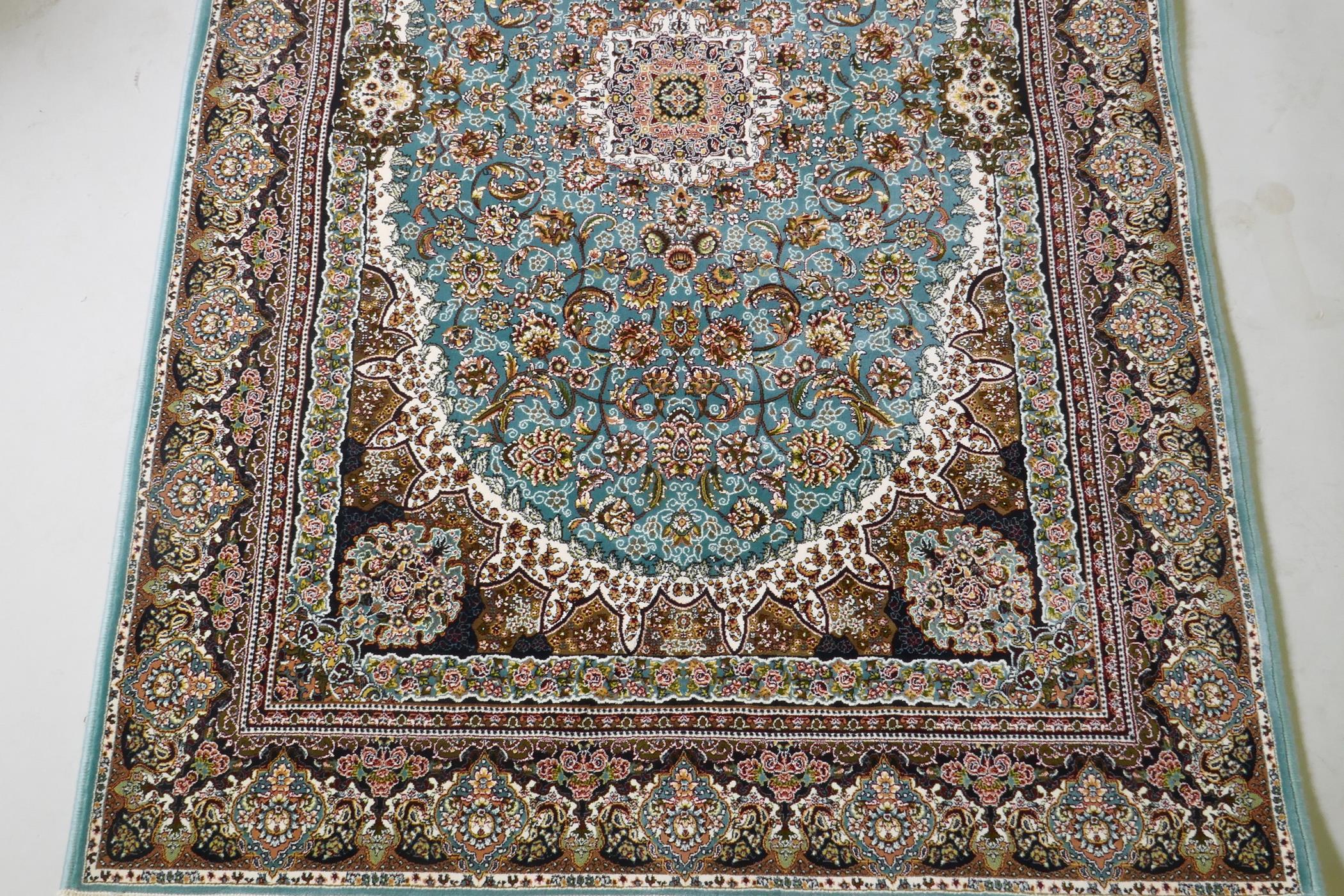 A fine woven full pile Iranian carpet with traditional floral medallion design on a turquoise field, - Image 3 of 5