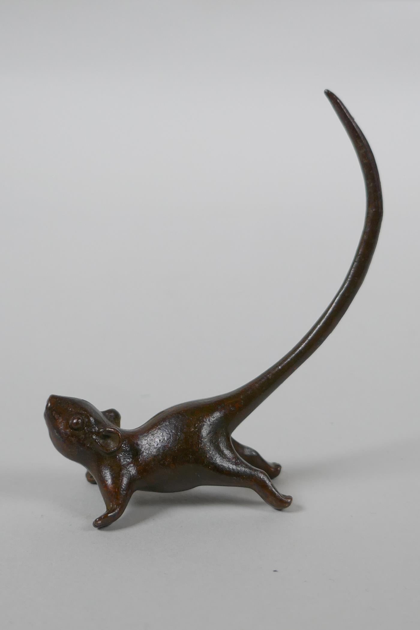 A Japanese style bronze okimono rat, 8cm high