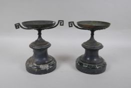 A pair of Grand Tour style bronze urns on marble socles, AF, 18cm high