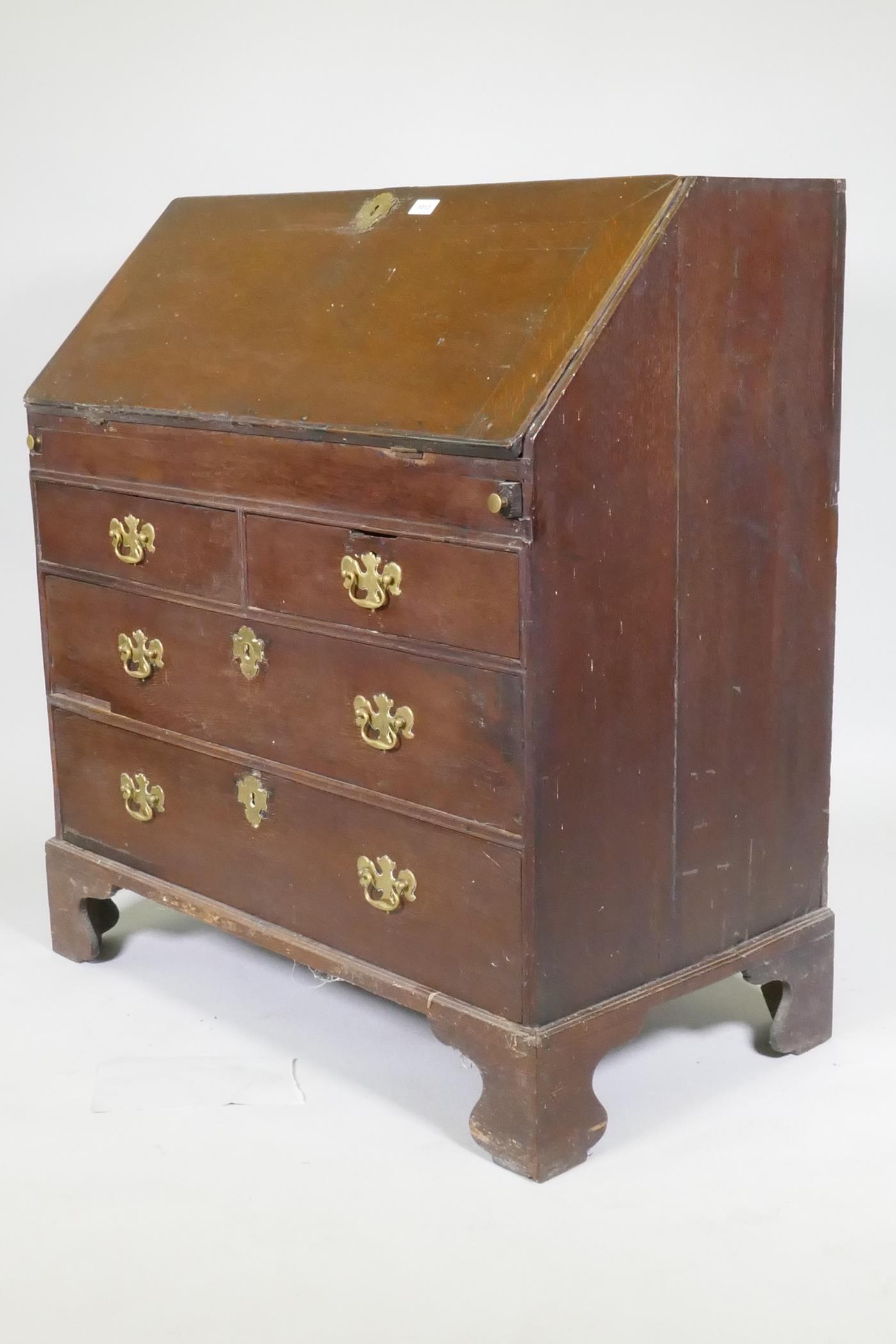 An early Georgian oak fall front bureau, the interior with drawers and pigeon holes and slide - Image 6 of 7