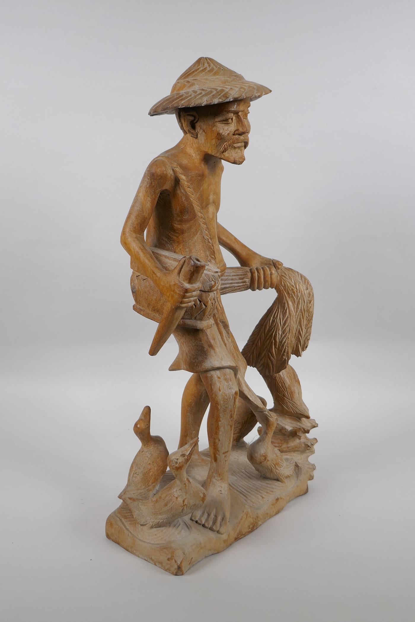 An oriental carved wood figure of a farmer surrounded by ducks, 46cm high - Image 3 of 5