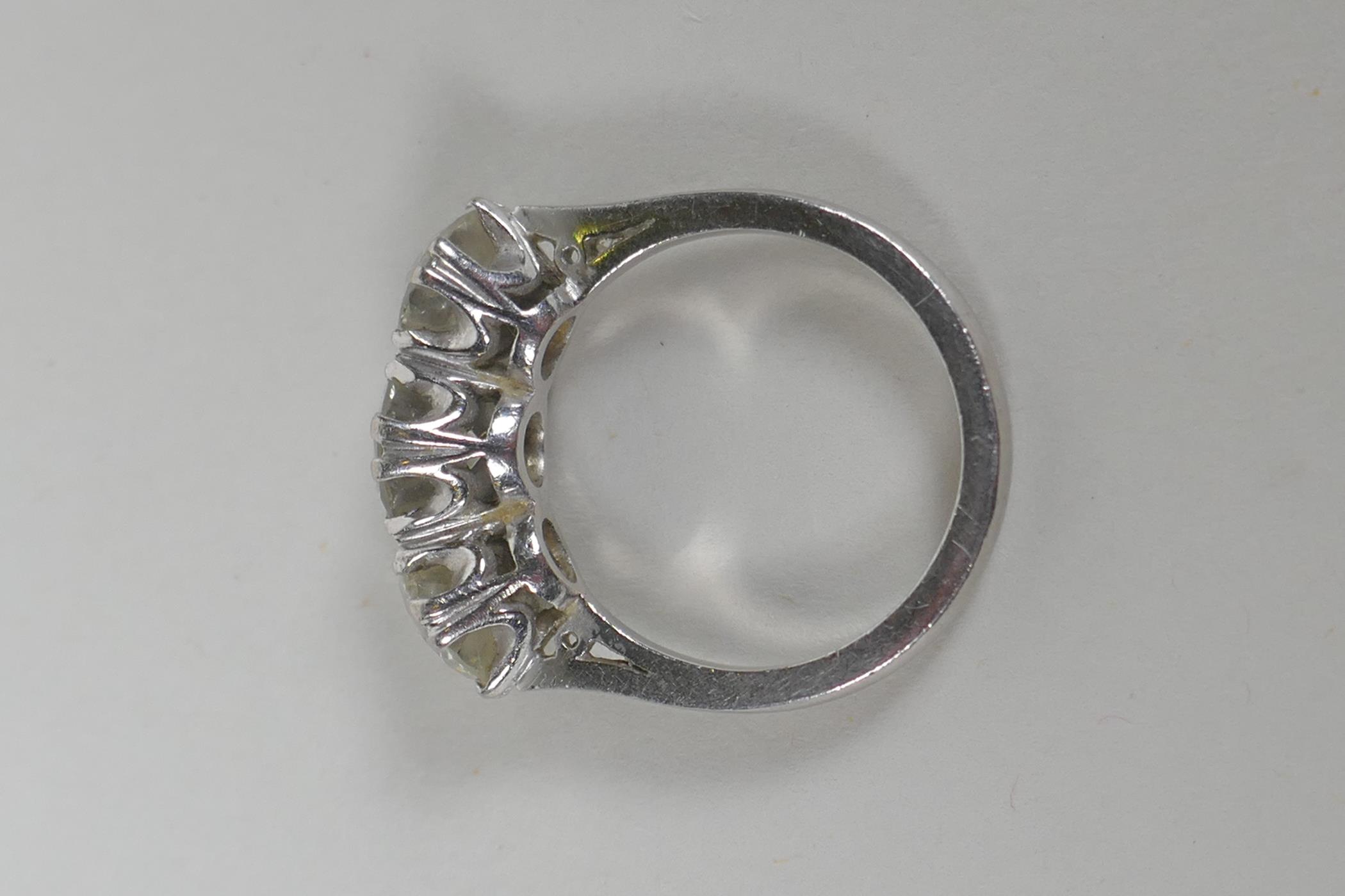 A platinum set three brilliant cut diamond ring, the central stone approx 0.95ct, flanking two - Image 8 of 8