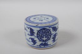 A Chinese blue and white porcelain drum shaped candlestick decorated with bats and auspicious