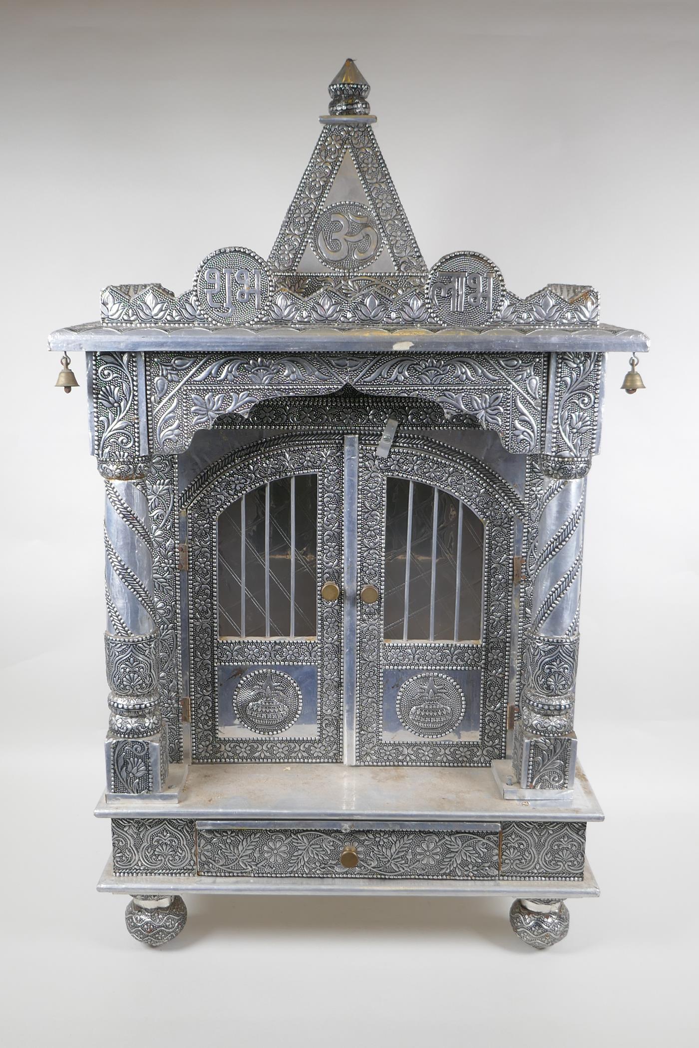 An Indian white metal veneered wooden table top shrine, 46 x 26cm, 82cm high