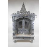 An Indian white metal veneered wooden table top shrine, 46 x 26cm, 82cm high