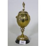 After August Cain, silver and gilt plated urn and cover, with stork finial, with raised decoration
