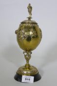 After August Cain, silver and gilt plated urn and cover, with stork finial, with raised decoration