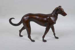 A filled bronze figure of a dog, 32cm long
