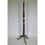 An antique mahogany standard lamp with carved reeded column and tripod supports, 145cm high