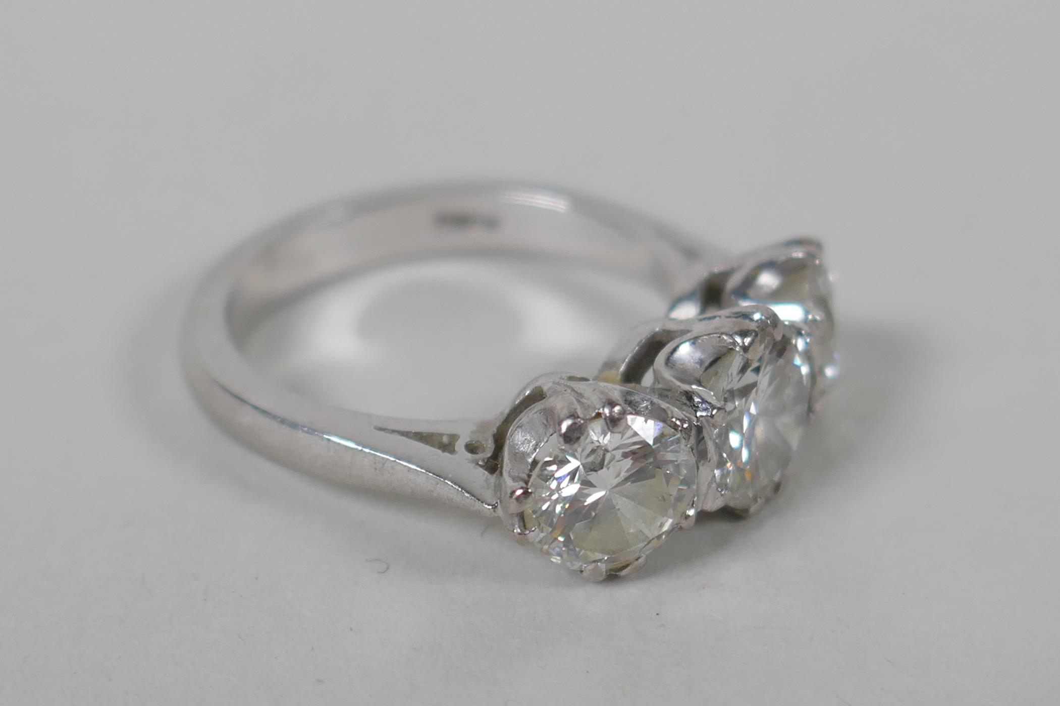 A platinum set three brilliant cut diamond ring, the central stone approx 0.95ct, flanking two - Image 2 of 8