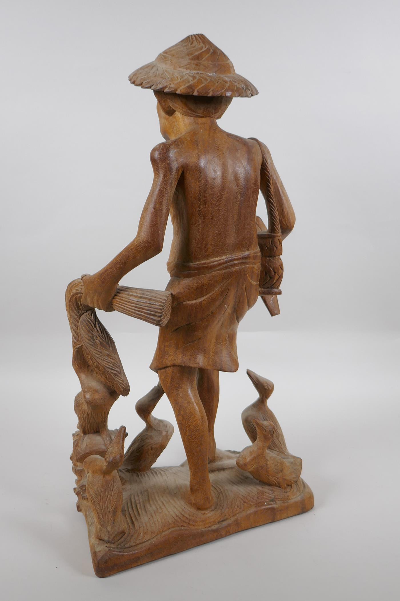 An oriental carved wood figure of a farmer surrounded by ducks, 46cm high - Image 4 of 5