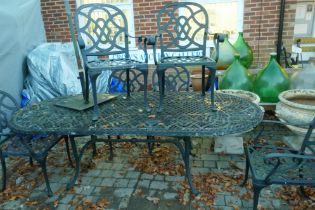 A painted aluminium extending garden table and six chairs