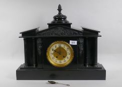 A C19th slate mantel clock of classical form, with carved decoration to the pediment and brass