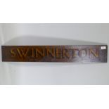 An antique wooden hand painted 'Swinnerton' sign, 92 x 15cm