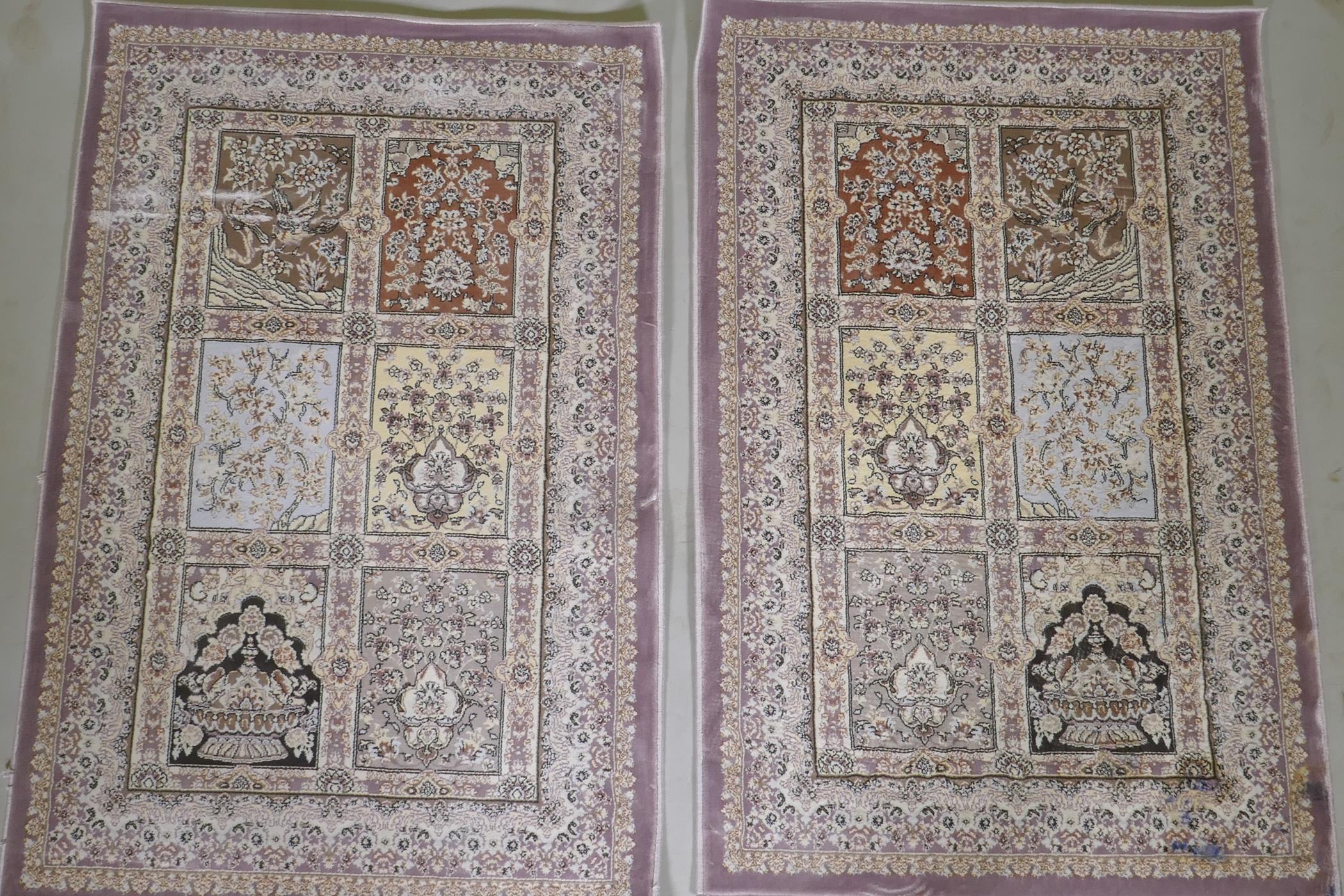 A pair of fine woven bamboo silk rugs with traditional Persian panel designs on a lilac coloured