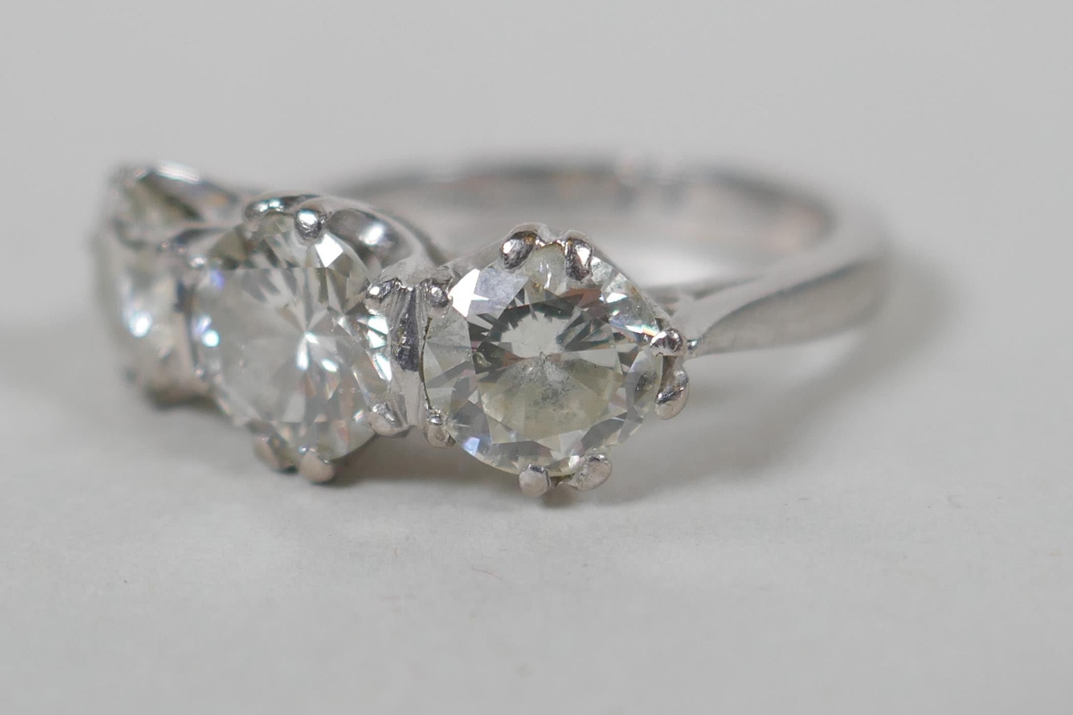 A platinum set three brilliant cut diamond ring, the central stone approx 0.95ct, flanking two - Image 6 of 8