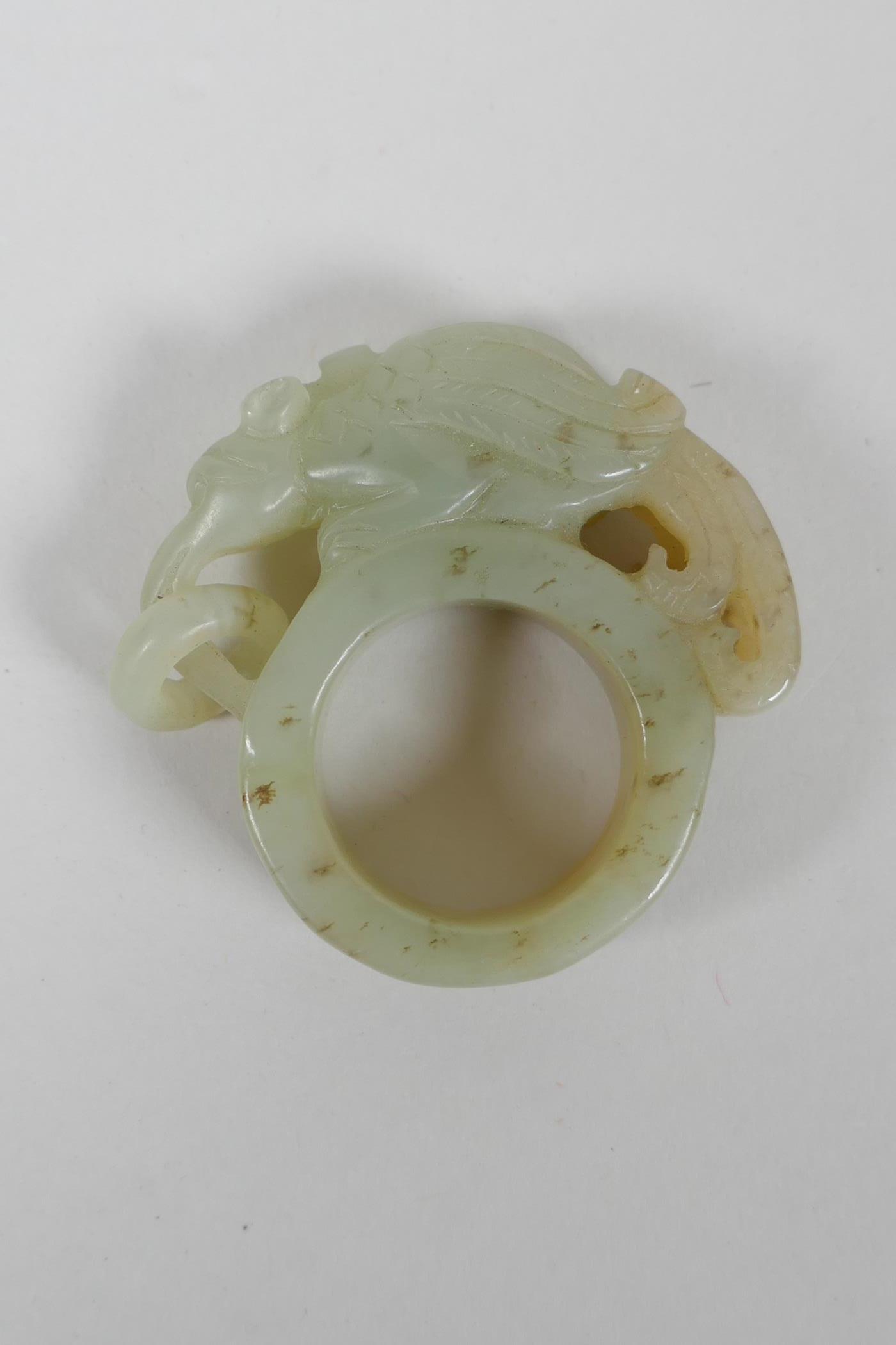 A Chinese Nephrite archers thumb ring with carved mythical creature decoration - Image 2 of 2