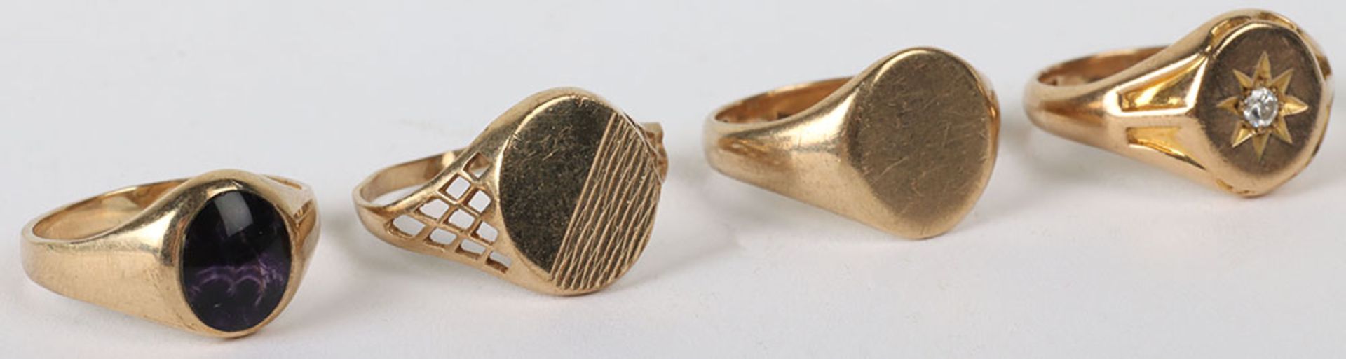 Four 9ct gold rings and one 22ct ring