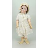 A Schoenau & Hoffmeister 1909 bisque head doll, German circa 1910,