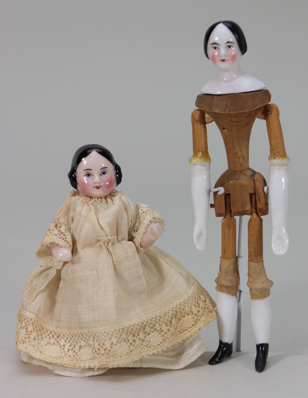 A miniature glazed china shoulder head doll on jointed wooden body, German mid 19th century,