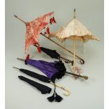 Five dolls parasols and umbrellas,