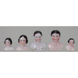 Five Early miniature glazed shoulder heads, German mid 19th century,