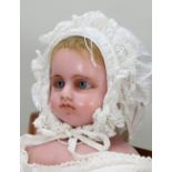 A Montinarie poured wax shoulder head doll, English 1870s,