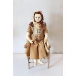 A small size wax over composition shoulder head doll, English circa 1850,