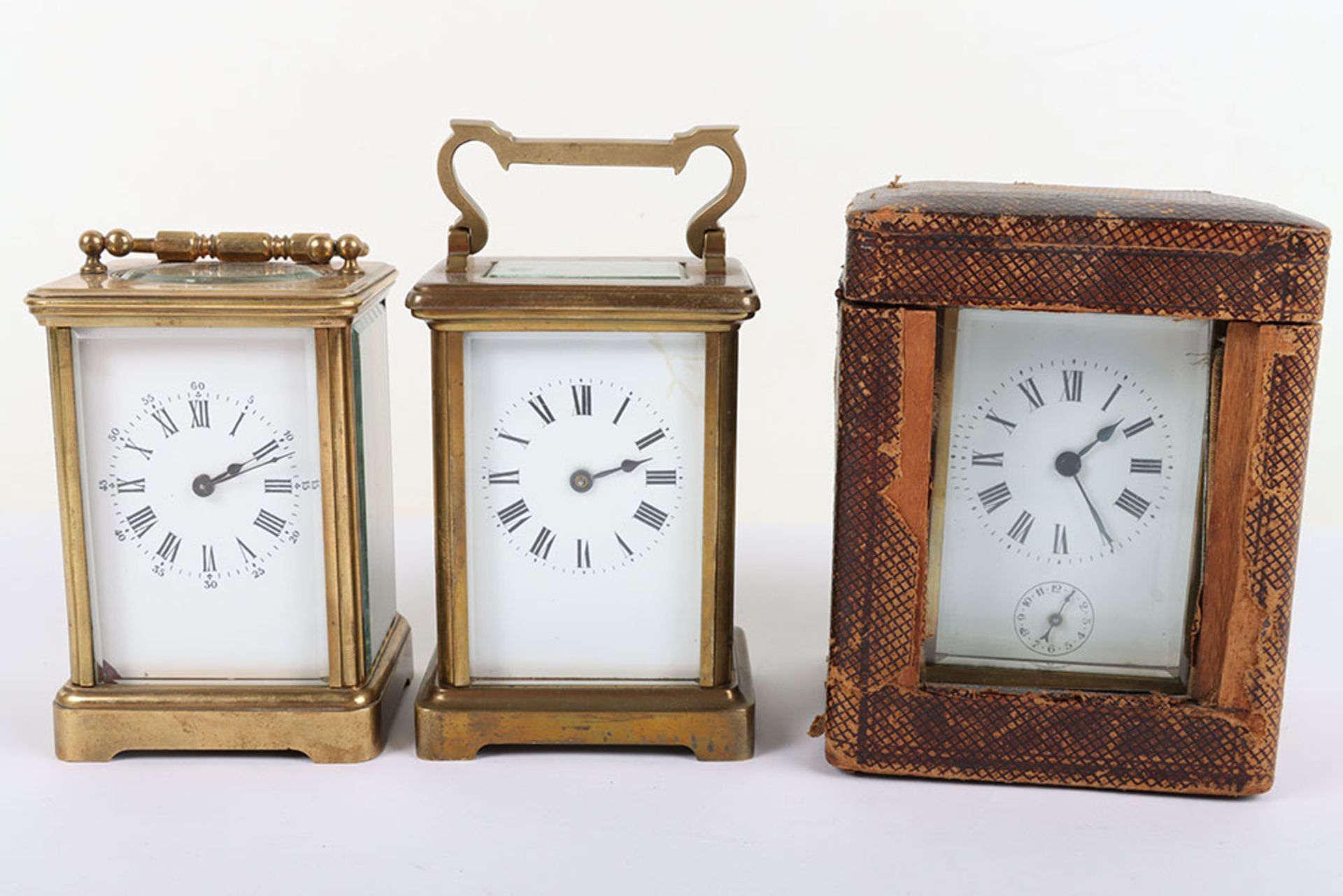 Three 20th century carriage clocks, including one with subisidiary dial and in travel case,