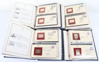 Various commemorative coin packs with five folders of 22ct Golden Replica of British Stamps