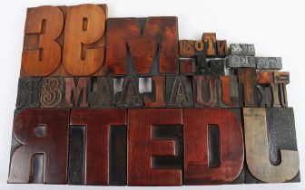 A selection of vintage wooden printing letterpress blocks and metal examples