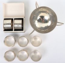 A silver hammered bowl, by Mappin & Webb, 1908, a pair of boxed napkin rings