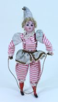 A bisque head clown squeak- toy doll in original clothes, French circa 1900,