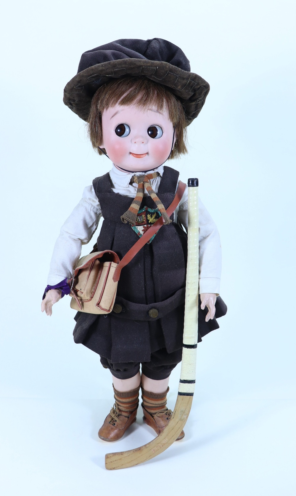 A rare large J.D Kestner 221 bisque head Googly doll in original school uniform, German circa 1911,