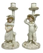 Pair of Royal Worcester figural candlesticks designed by James Hadley in the style of Kate Greenaway