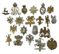 Twenty-one cap badges including 1st Queens Dragoon Guards