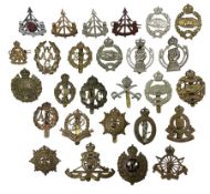 Twenty-seven military metal cap badges including Royal tank Corps