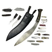 WW2 Gurkha Kukri knife with 34cm curving steel blade and horn handle; in leather covered scabbard wi