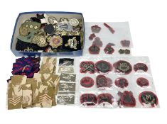 Large quantity of military embroidered cloth badges including shoulder sliders and titles