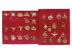 Thirty-two cap badges including Parachute Regiment