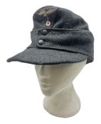 WW2 German Luftwaffe M43 field cap with triangular cloth eagle and roundel badge; marked '1944 ?/050