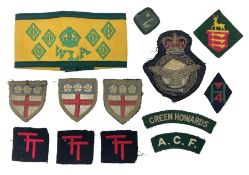 WW2 Women's Land Army six-year service armband in yellow and green; and small quantity of cloth badg