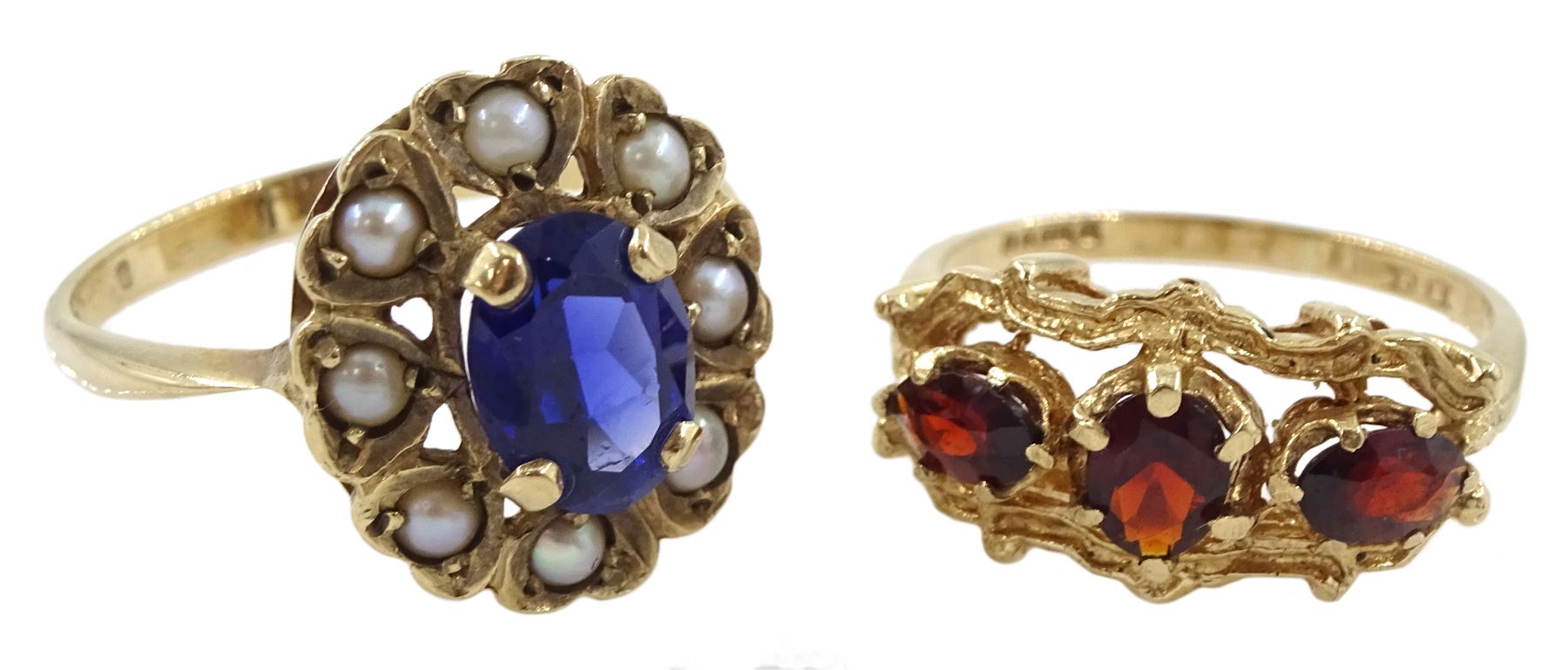 Gold three stone garnet ring and a gold pearl and blue paste stone set cluster ring