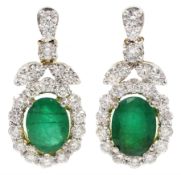 Pair of 18ct gold oval emerald and round brilliant cut diamond pendant stud earrings