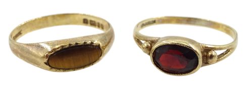 Gold oval garnet ring and a gold tiger's eye ring