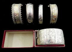 Two 19th/early 20th century silver bangles with two tone foliate bright cut decoration