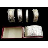 Two 19th/early 20th century silver bangles with two tone foliate bright cut decoration